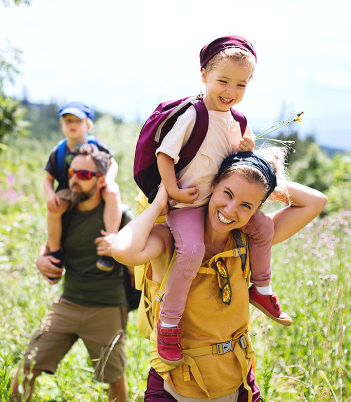 A happy family hiking outdoors together